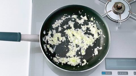 Sautéing ginger and scallion stems in a frying pan to make the filling for Harumaki.