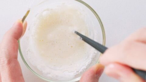 Preparing flour glue for sealing spring rolls shut.