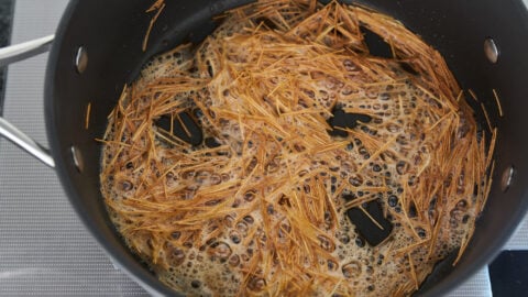 Browning vermicelli in butter for making Hashweh.