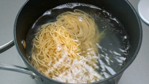 Boiling ramen noodles for making chilled ramen salad.