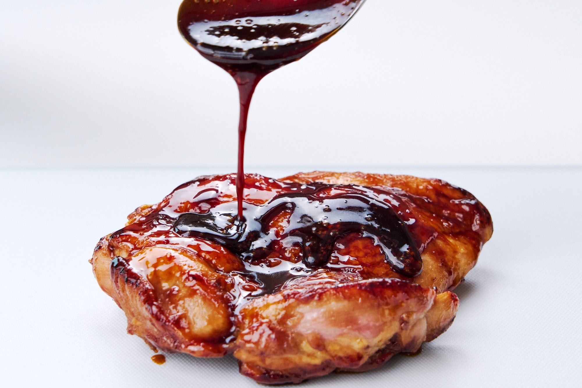 Drizzling authentic Japanese teriyaki sauce over chicken.