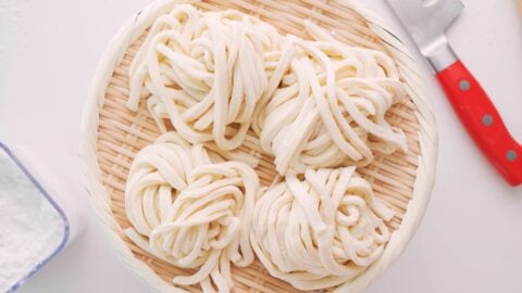 Nests of fresh hand-cut udon noodles in a basket.