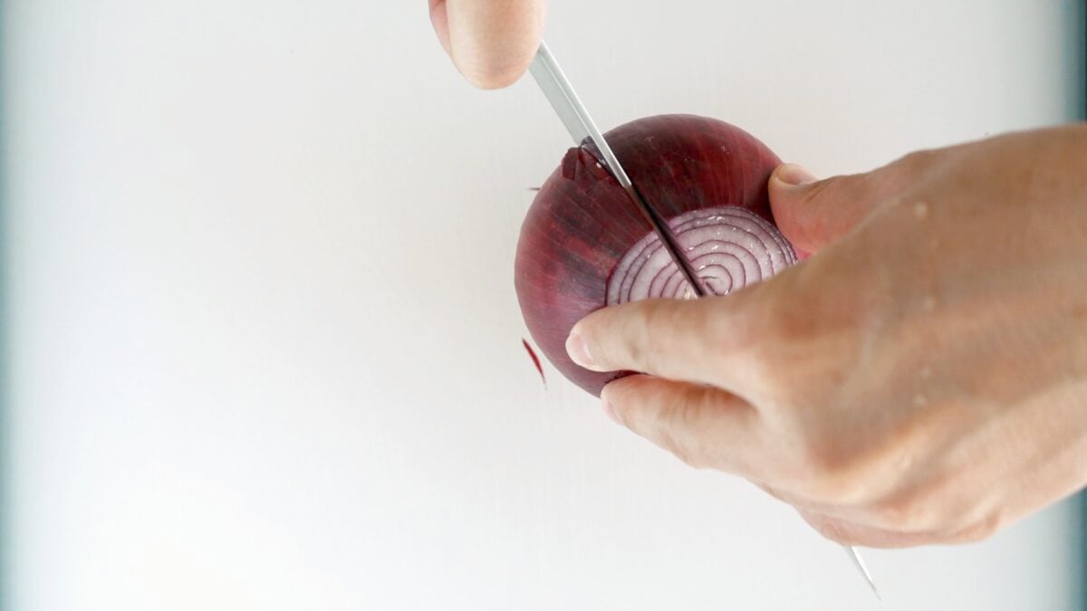 Slice the onion in half from the top to root end. 