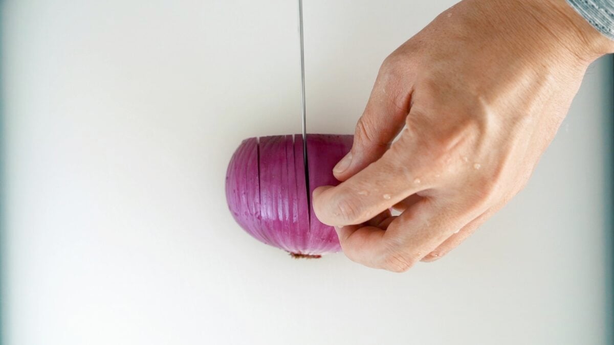 Add vertical slits in the onion from the top to nearly the root end.