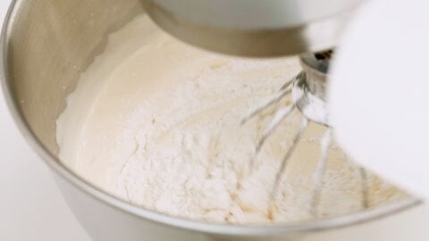 Adding flour to sponge cake batter.