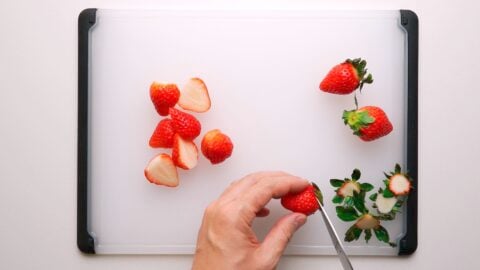 Cutting strawberries for Christmas Cake.