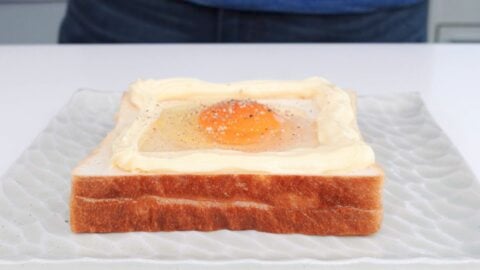 Add egg on top of toast and season with salt and pepper.