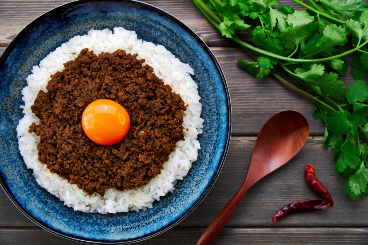 This spicy, savory and easy to make keema curry is served on a bed of rice with a golden orb of egg yolk.