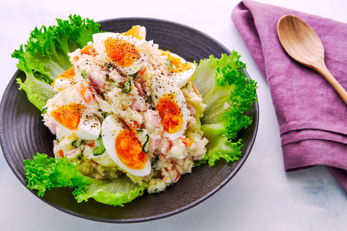 Easy, colorful Japanese Potato Salad recipe with boiled eggs, ham, cucumbers, carrots, and onions.