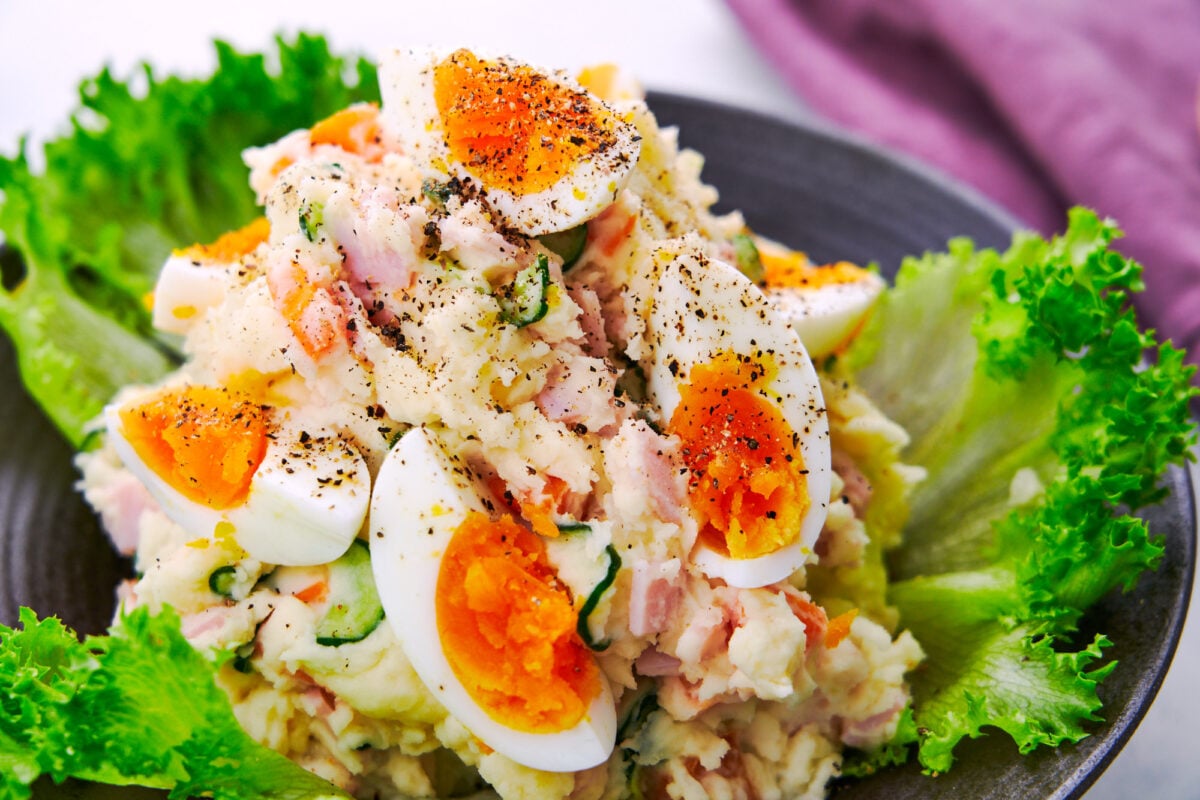 Japanese potato salad with boil eggs, ham, cucumbers, carrots, and onions.