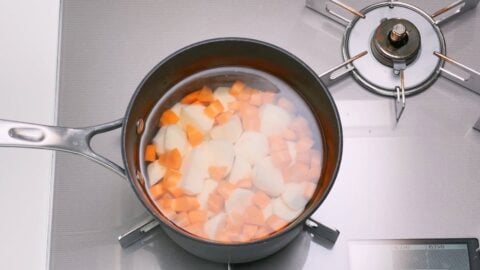 Boiling potatoes and carrots for salad.