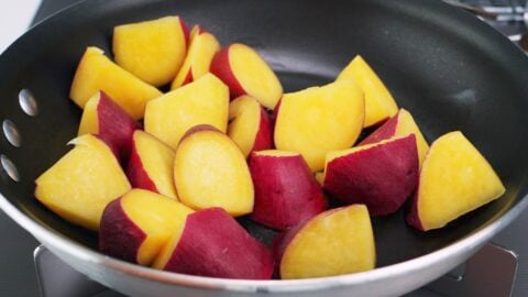 Steamed Japanese sweet potatoes in a frying pan.