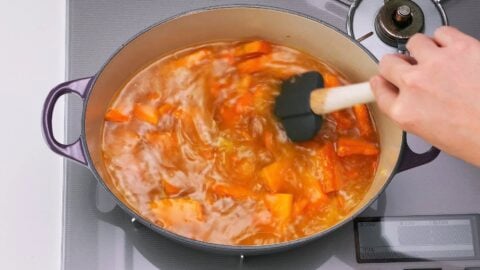 Stirring Kabocha squash soup with a spatula.