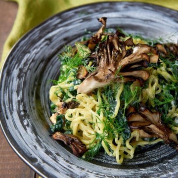 With a creamy garlic lemon sauce, curly ramen noodles, lacinato kale, dill and roasted maitake mushrooms, this salad makes for a delicious light meal.