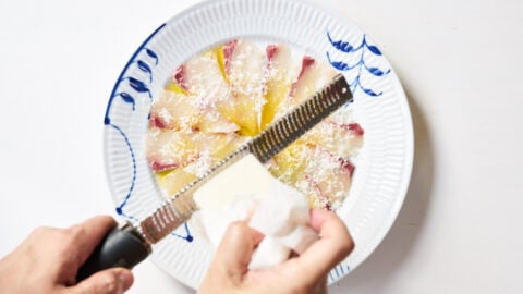 Kanpachi and olive oil having Pecorino Romano grated on top.