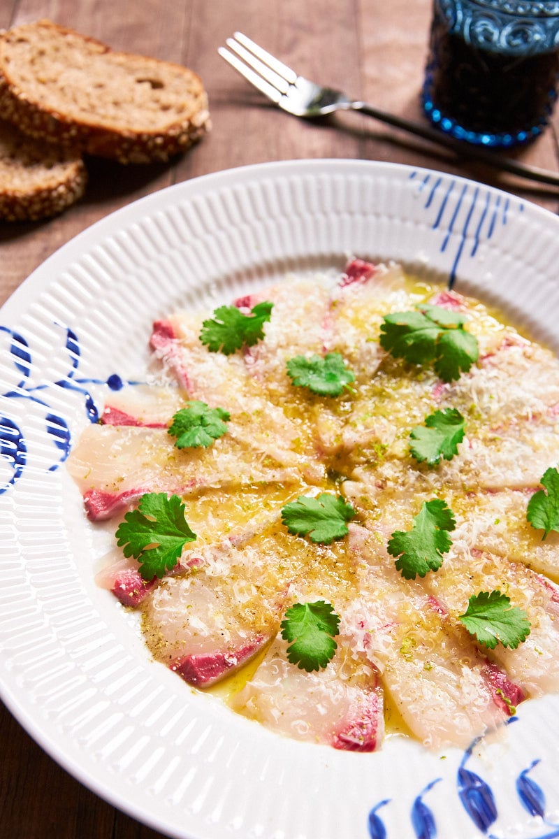 Kanpachi Carpaccio (Kanpaccio) is an impressive appetizer that's as simple as slicing the fish and topping it with olive oil, salt, cheese and lime zest.