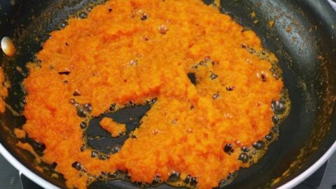 Burning off water from grated aromatics in a frying pan.