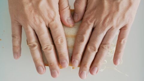 Use your hands to press on the Katsu Sandwich to help the bread conform to the cutlet.