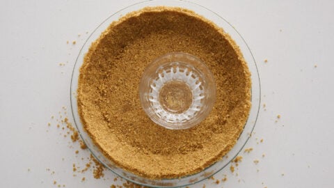 Pressing graham cracker crumbs into pie dish for key lime pie.