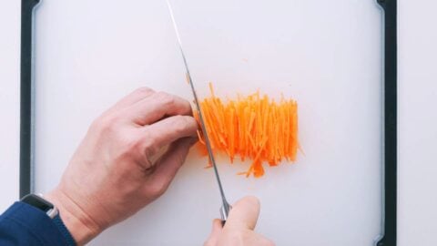 Cutting carrots into a thin julienne.