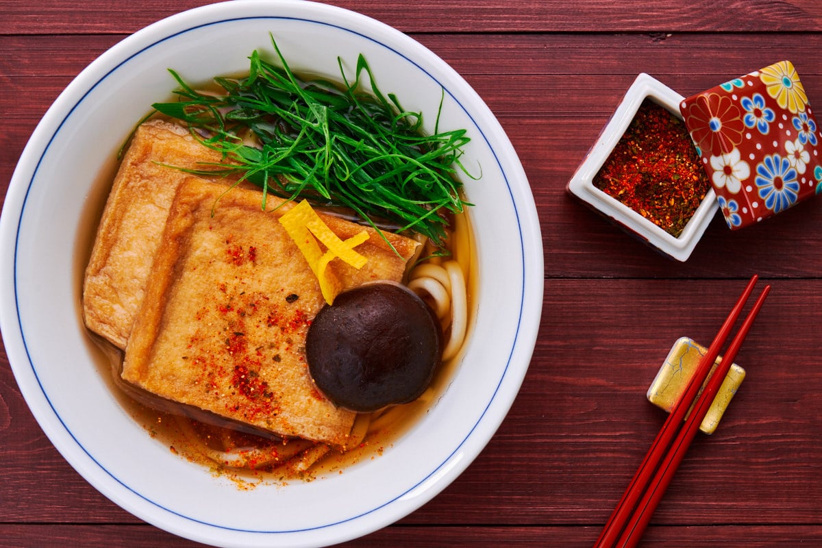 Warm up with a piping hot bowl of Kitsune Udon topped with savory-sweet fried tofu, scallions and yuzu.