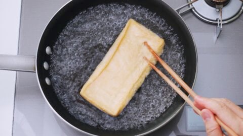 Boil the aburaage to get rid of any excess oil in the tofu.