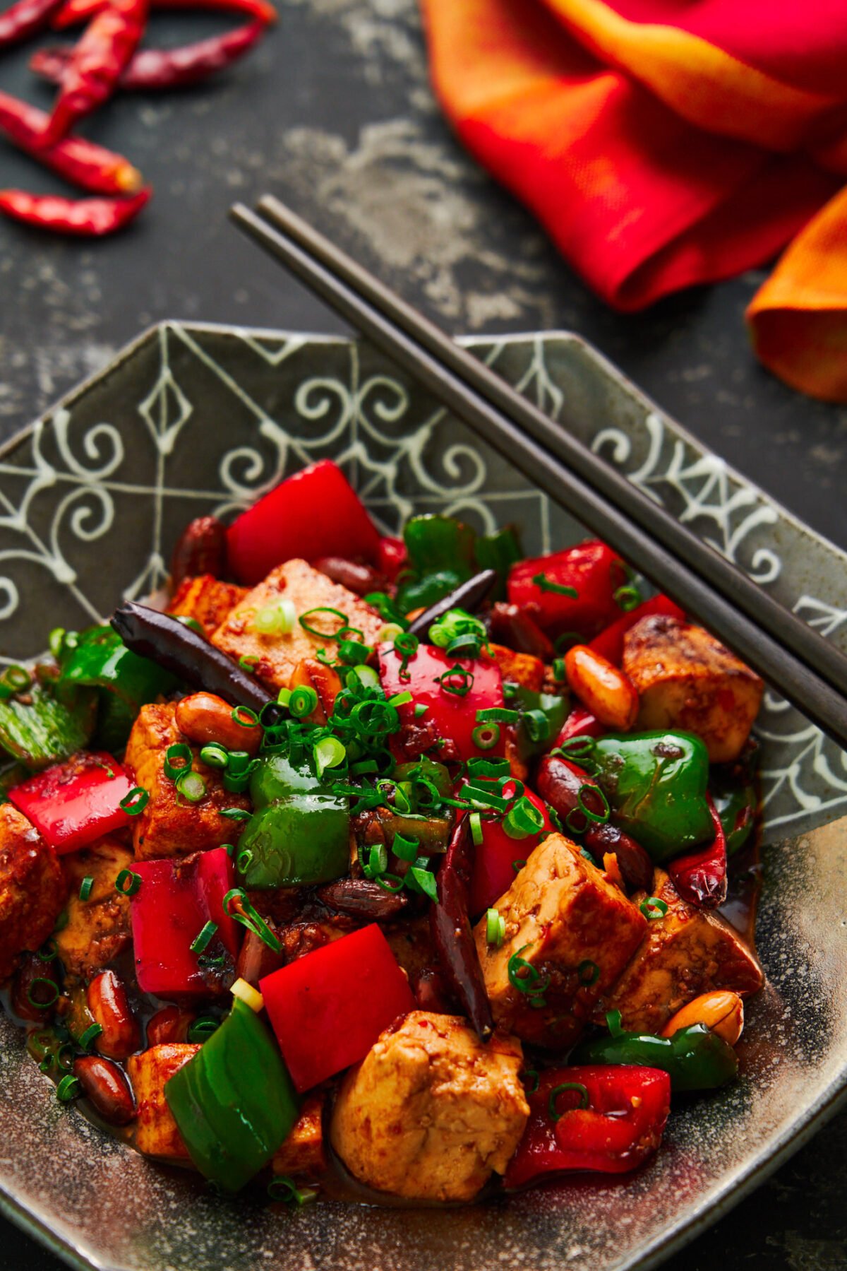 With meaty chunks of tofu that are seasoned to the core, crunchy peanuts, and crisp peppers glazed in a mouthwatering savory, sweet, sour, and spicy sauce, this easy Kung Pao Tofu is a delicious stir-fry that may be meatless, but it's flavor full!