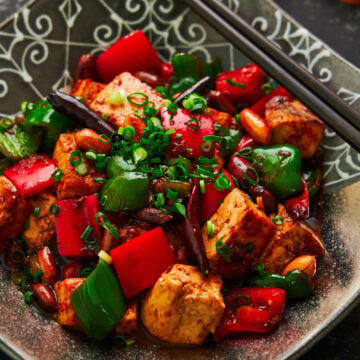 With meaty chunks of tofu that are seasoned to the core, crunchy peanuts, and crisp peppers glazed in a mouthwatering savory, sweet, sour, and spicy sauce, this easy Kung Pao Tofu is a delicious stir-fry that may be meatless, but it's flavor full!