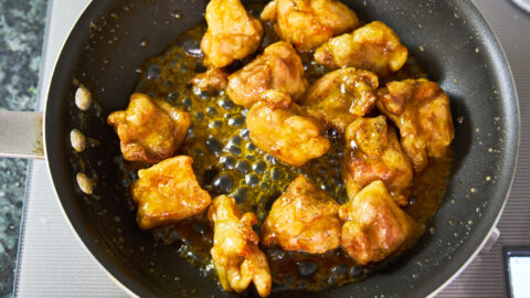 Lemon chicken in a non-stick pan on the stove.