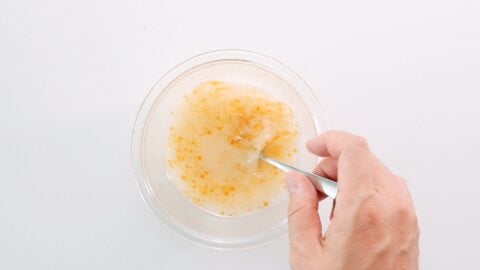 Whisking chicken stock, potato starch and sesame oil together in a bowl for Mapo Tofu sauce.