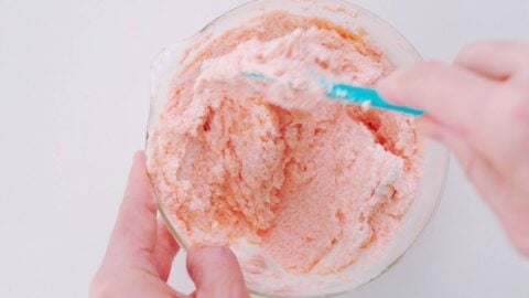 Mixing mentaiko bread spread in a glass bowl.