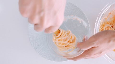 Plating Mentaiko pasta using a bowl.