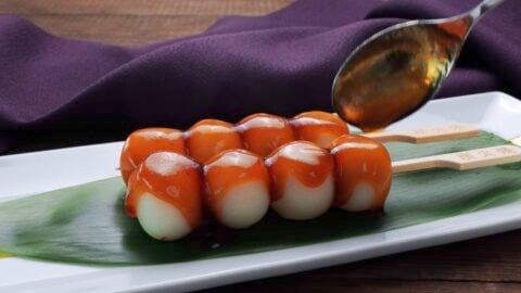 Glazing Mitarashi Dango with sauce.