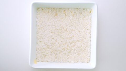 Layer of rice in buttered casserole dish.