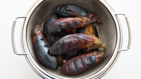 Char-roasted eggplant in strainer for Mutabbal.