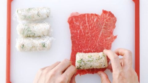 Wrapping onigiri in thin sheets of beef.