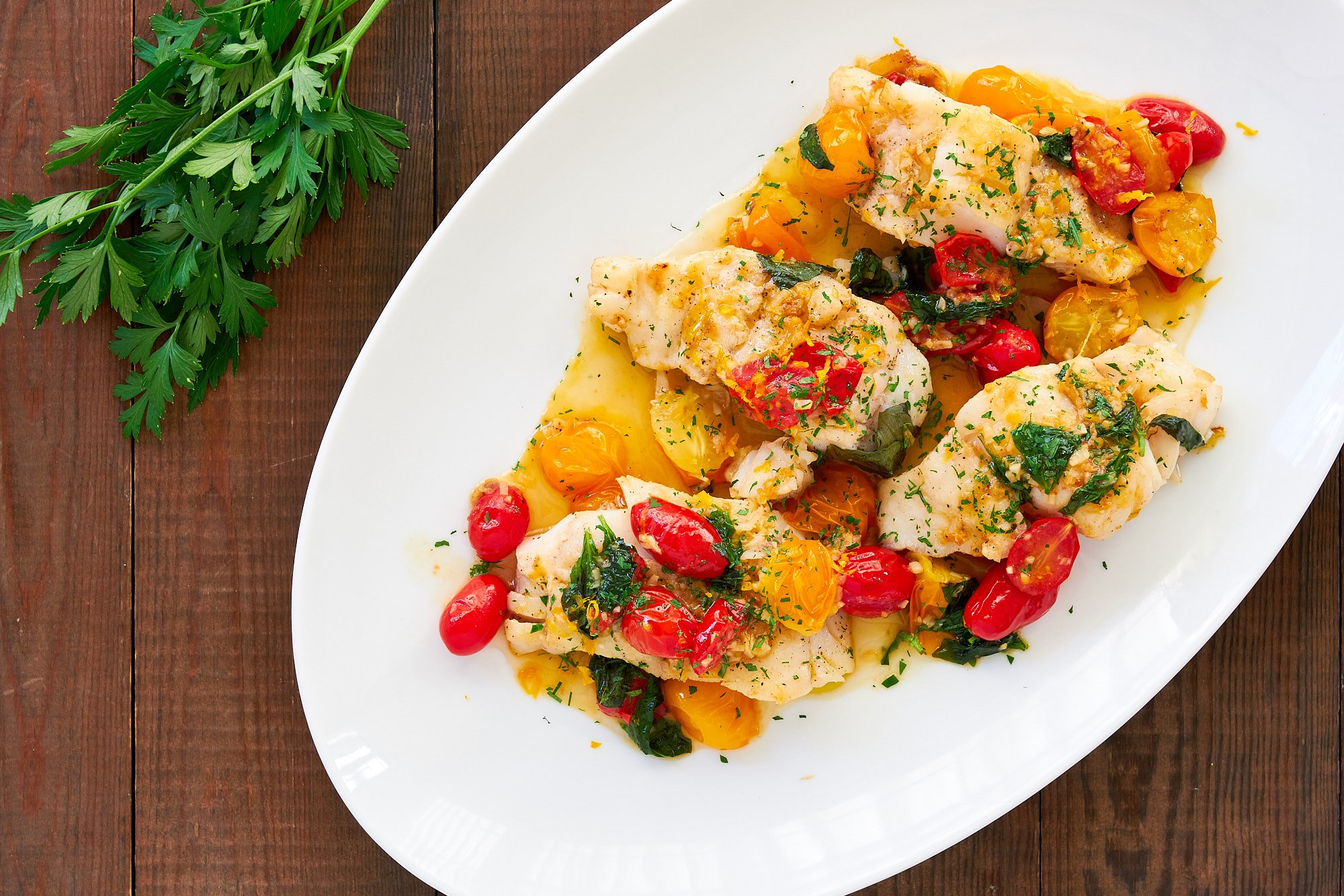 Easy and delicious, this pan-roasted cod with a white wine and cherry tomato pan-sauce is the perfect weeknight meal.