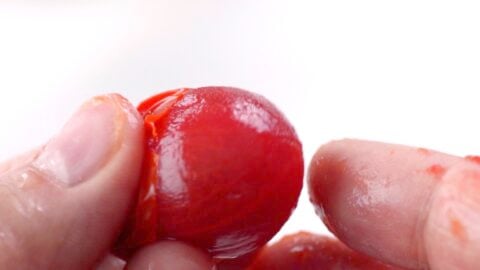 Peeling cherry tomato.