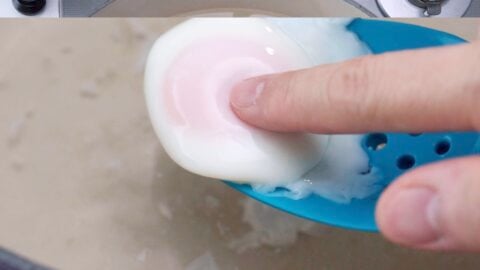 Test the eggs for doneness by poking the yolk with your finger.