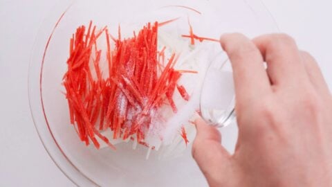 Salting carrots and daikon to pickle