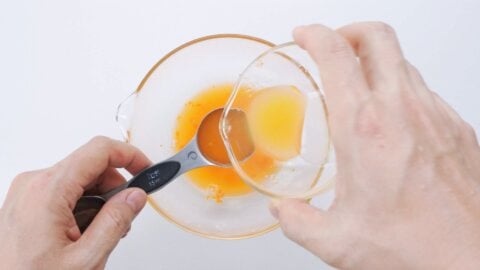 Measuring citrus juice into a glass bowl for making Ponzu.