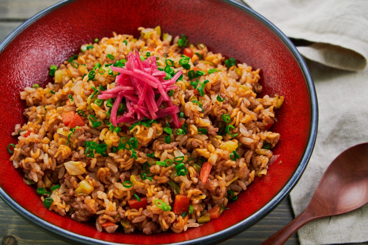 A plate of the Kobe specialty sobameshi combines fried rice and stir-fried ramen noodles topped with red pickled ginger and scallions.