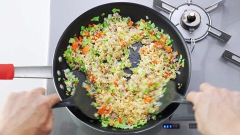 Stir-frying ramen noodles and vegetables for ramen fried rice.