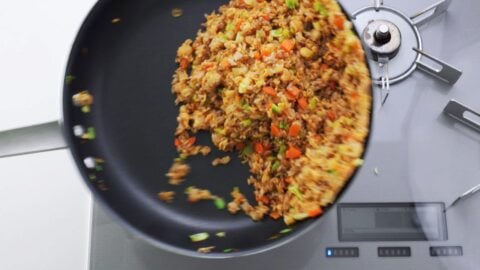 Tossing sobameshi (ramen fried rice) in a frying pan.