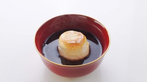 Bowl of oshiruko topped with a piece of toasted mochi.