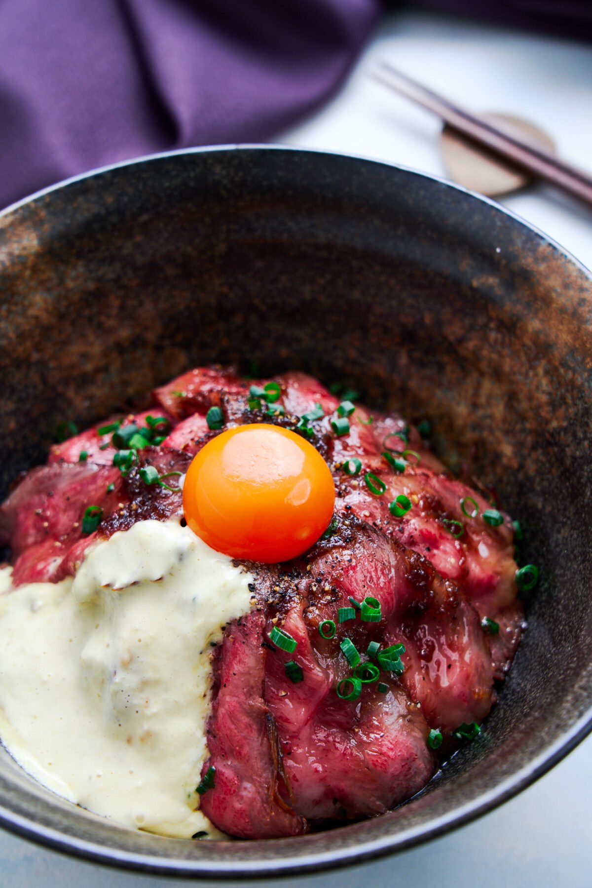 Easy stove top Japanese roast beef rice bowl with pan roasted A5 grade wagyu, an onion glaze, and tangy wasabi cream.