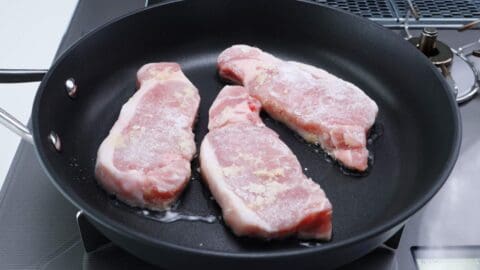 Ginger pork chops in a frying pan.