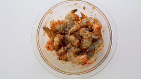 Marinating shrimp in garlic, smoked paprika, salt and pepper.