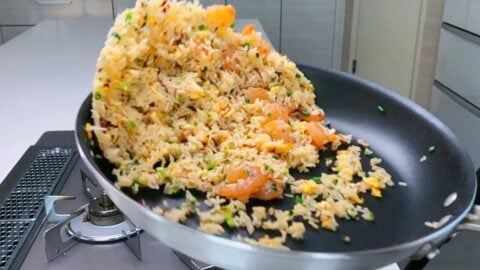 Tossing Shrimp Fried Rice in a frying pan.