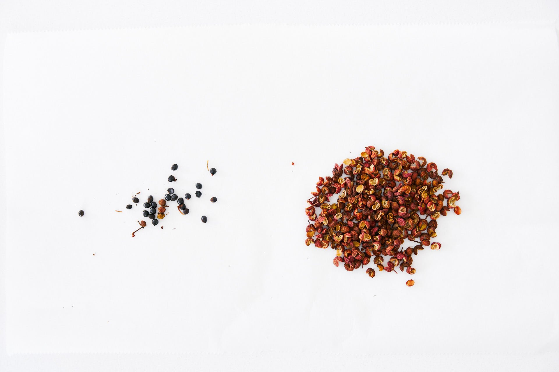 Sichuan peppercorn hulls (right) seperated from seeds (left).